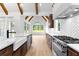 Bright kitchen with stainless steel appliances, white counters, wooden beams, and eat-in area with large windows at 210 Regester Way, Peachtree City, GA 30269