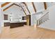 Open-concept kitchen with hardwood floors, modern island and stairs leading to the upper level at 210 Regester Way, Peachtree City, GA 30269
