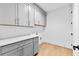 Laundry room with grey cabinetry, light countertops, and washer and dryer hookups ready for appliances at 210 Regester Way, Peachtree City, GA 30269