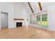 Open living space with large windows, fireplace and hardwood flooring that offers ample natural light at 210 Regester Way, Peachtree City, GA 30269