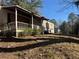 Exterior view of home showing porch and yard needing repair at 2284 Beecher Sw Cir, Atlanta, GA 30311