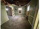 View of living room with damaged ceiling, walls and missing trim needing repair at 2284 Beecher Sw Cir, Atlanta, GA 30311