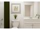 Contemporary bathroom featuring a green shower curtain, toilet, white vanity, and artwork at 2489 Cotton Ln, Douglasville, GA 30135