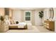 A bright bedroom features a neutral palette, accent furniture, and a window with a tree view at 2489 Cotton Ln, Douglasville, GA 30135
