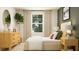 Inviting bedroom with neutral walls, soft bedding, wood furniture, and bright natural light at 2489 Cotton Ln, Douglasville, GA 30135