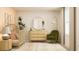 Serene Bedroom featuring a light wood crib, green rocking chair, circular mirror, and natural light at 2489 Cotton Ln, Douglasville, GA 30135