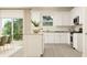 Modern kitchen with white cabinets, granite countertops, stainless steel appliances, and an open dining area at 2489 Cotton Ln, Douglasville, GA 30135