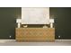 Elegant living room showcasing a stylish console table, lamps, and artwork against a dark green wall at 2489 Cotton Ln, Douglasville, GA 30135
