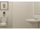 Small powder room has pedestal sink, toilet, and neutral paint at 2489 Cotton Ln, Douglasville, GA 30135