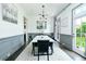 Spacious dining room features elegant wainscoting, modern lighting, and access to the outdoor space at 538 Micayne Cir # 3, Smyrna, GA 30082