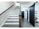A bright foyer with hardwood stairs, black doors and a modern sliding barn door at 538 Micayne Cir # 3, Smyrna, GA 30082