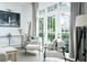 Sunlit living room features chairs and a pair of french doors that leads to the outside at 538 Micayne Cir # 3, Smyrna, GA 30082
