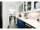 Bright pantry features blue cabinetry, subway tile backsplash, and modern appliances at 538 Micayne Cir # 3, Smyrna, GA 30082