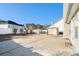 Backyard featuring a concrete patio, a small shed, and some bushes and trees at 7492 Ferrara Dr, Lithonia, GA 30058