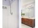 Modern bathroom featuring a shower head and vanity with a sink, mirror, and light fixture at 7492 Ferrara Dr, Lithonia, GA 30058