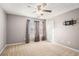 Spacious bedroom featuring soft carpet, ceiling fan, and window with privacy blinds at 7492 Ferrara Dr, Lithonia, GA 30058