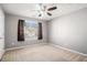 Bedroom with neutral paint and carpet plus a large window provides a comfortable living space at 7492 Ferrara Dr, Lithonia, GA 30058