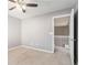 View of a room with neutral colored walls, carpet, ceiling fan, and white trim and door at 7492 Ferrara Dr, Lithonia, GA 30058