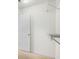 Spacious walk-in closet with white door, neutral carpet, and storage shelves for optimal organization at 7492 Ferrara Dr, Lithonia, GA 30058