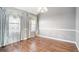 Bright dining room with hardwood floors, chandelier, and large windows with elegant curtains at 7492 Ferrara Dr, Lithonia, GA 30058
