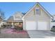 Charming two-story home featuring a two-car garage and covered front porch at 7492 Ferrara Dr, Lithonia, GA 30058