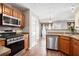 Well-equipped kitchen with stainless steel appliances, modern cabinetry and breakfast nook at 7492 Ferrara Dr, Lithonia, GA 30058