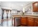 Bright kitchen featuring stainless steel appliances, granite counters and view to dining area at 7492 Ferrara Dr, Lithonia, GA 30058
