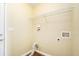 Functional laundry room featuring hardwood floors, wired outlets, and a wire rack for storage at 7492 Ferrara Dr, Lithonia, GA 30058
