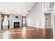 Spacious living room with hardwood floors, a fireplace, and large windows with custom curtains at 7492 Ferrara Dr, Lithonia, GA 30058