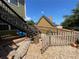The backyard shows a wood fence, stone border, and wooden stairs up to a deck at 140 Puckett Creek Dr, Canton, GA 30114