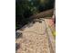 Backyard area with gravel, a fire pit, tree-trunk seating, and pavers, great for outdoor gatherings and enjoyment at 140 Puckett Creek Dr, Canton, GA 30114
