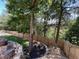 A lush backyard with tall trees and manicured landscaping surrounded by a wood fence at 140 Puckett Creek Dr, Canton, GA 30114