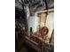 Image displays a hot water tank installed on the wall surrounded by exposed pipes and insulation at 140 Puckett Creek Dr, Canton, GA 30114