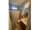 Bathroom featuring a shower with curtain, tile floors, and cabinet storage at 140 Puckett Creek Dr, Canton, GA 30114