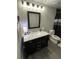 Bathroom with updated vanity, mirror, and modern lighting fixture at 140 Puckett Creek Dr, Canton, GA 30114