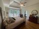 Spacious bedroom with a tray ceiling, hardwood floors, and a large window at 140 Puckett Creek Dr, Canton, GA 30114