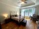 Comfortable bedroom with hardwood floors, a ceiling fan, and natural light at 140 Puckett Creek Dr, Canton, GA 30114