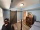 Charming bedroom features blue walls, a wooden barn door, and a four-poster bed frame at 140 Puckett Creek Dr, Canton, GA 30114