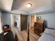 Cozy bedroom with blue walls, barn door, wood floors, and a classic wooden bed frame at 140 Puckett Creek Dr, Canton, GA 30114