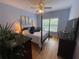Comfortable bedroom featuring a ceiling fan, wooden floors, and natural light from a window at 140 Puckett Creek Dr, Canton, GA 30114