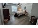 Large bedroom with neutral walls, tray ceiling, ceiling fan, and luxury vinyl plank flooring at 140 Puckett Creek Dr, Canton, GA 30114