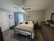 Neutral toned bedroom featuring wood-look floors, a fan, and natural light at 140 Puckett Creek Dr, Canton, GA 30114