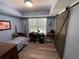 Bright bedroom with large window and a barn door, a desk, and natural light creating a comfortable space at 140 Puckett Creek Dr, Canton, GA 30114