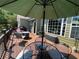 Deck with an umbrella-covered dining area and outdoor seating, ideal for outdoor gatherings at 140 Puckett Creek Dr, Canton, GA 30114