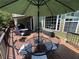 Deck with an umbrella-covered dining area and outdoor seating, ideal for outdoor gatherings at 140 Puckett Creek Dr, Canton, GA 30114