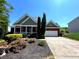 Front exterior view of a brick home with two car garage and mature landscaping at 140 Puckett Creek Dr, Canton, GA 30114