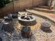 A stone fire pit area surrounded by pea gravel and wooden log seating for outdoor gatherings at 140 Puckett Creek Dr, Canton, GA 30114