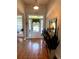 Bright foyer with hardwood floors, featuring a glass front door and transom window at 140 Puckett Creek Dr, Canton, GA 30114