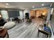 Open-concept living room featuring gray vinyl flooring, a movie screen and comfortable seating at 140 Puckett Creek Dr, Canton, GA 30114