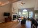 Cozy living room with a fireplace, hardwood floors, and a wall of windows at 140 Puckett Creek Dr, Canton, GA 30114